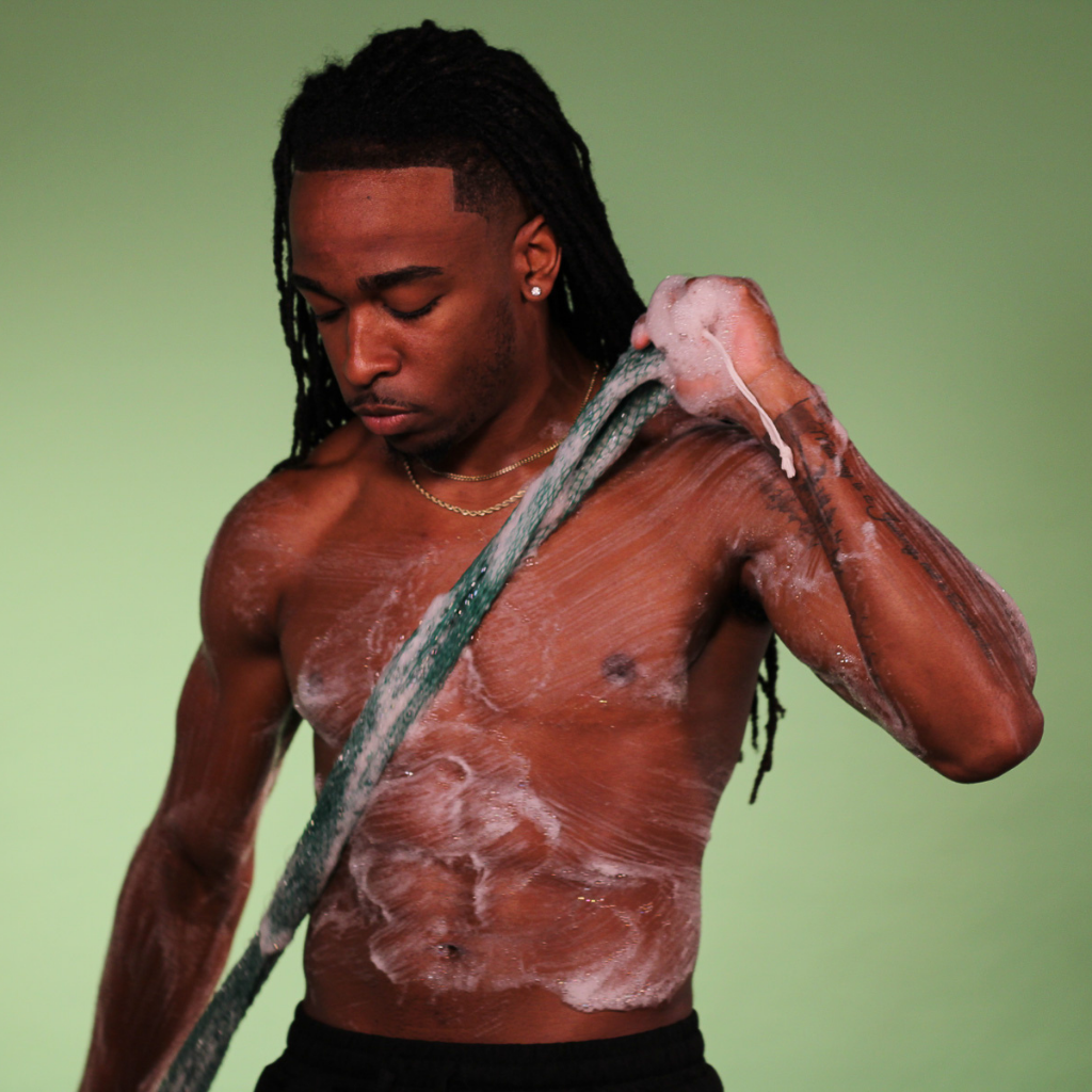man using African net sponge for body exfoliation and skin cleansing
