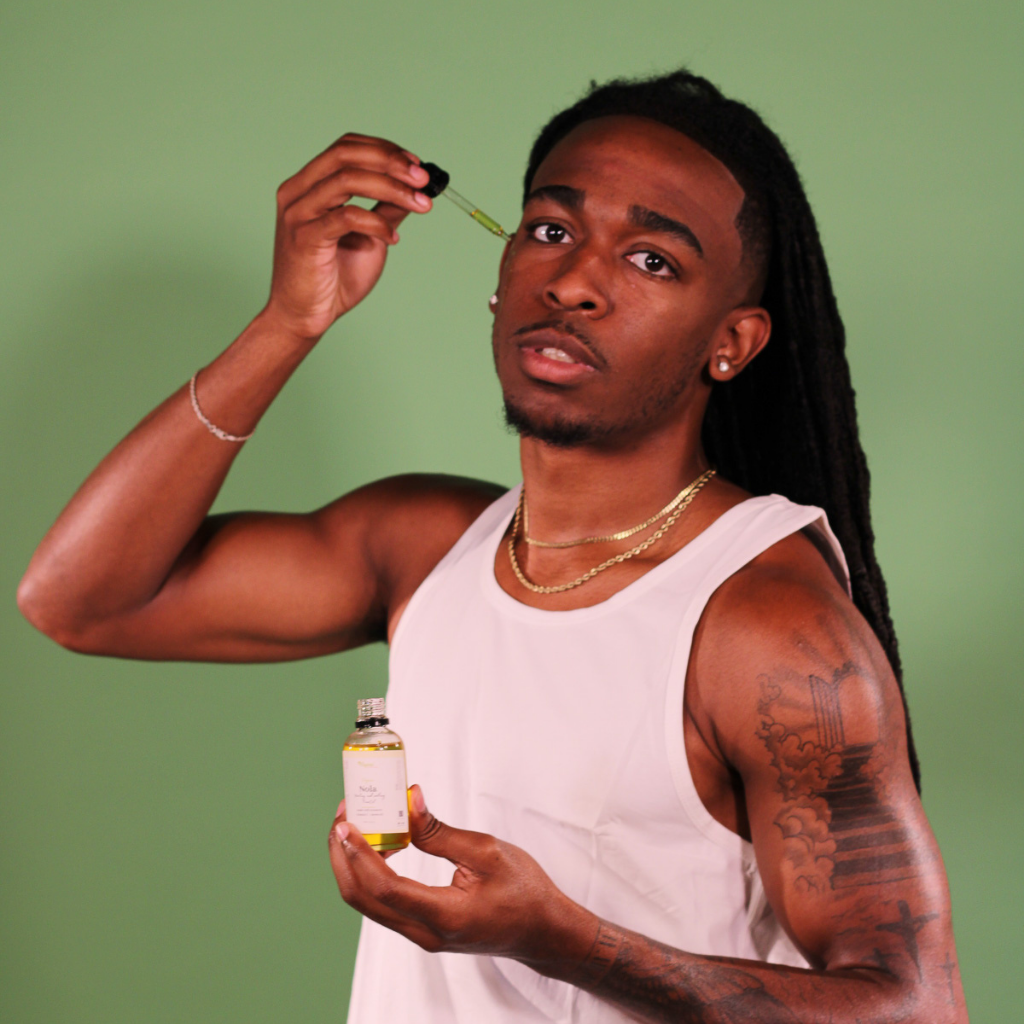 Man applying Organic Nola Face Oil