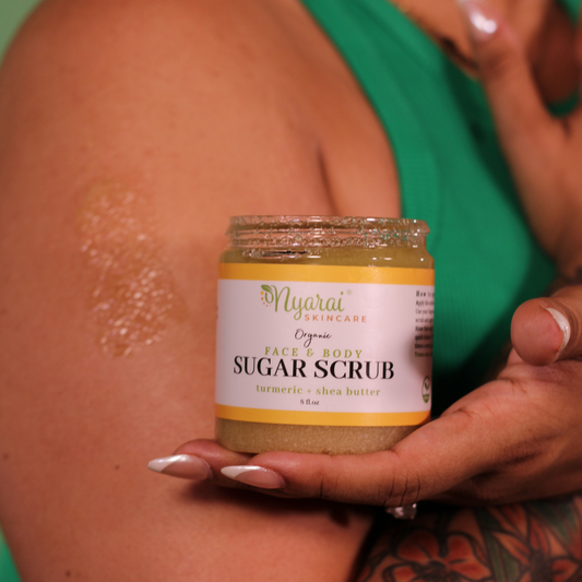 Woman holding Turmeric face and body scrub Jar