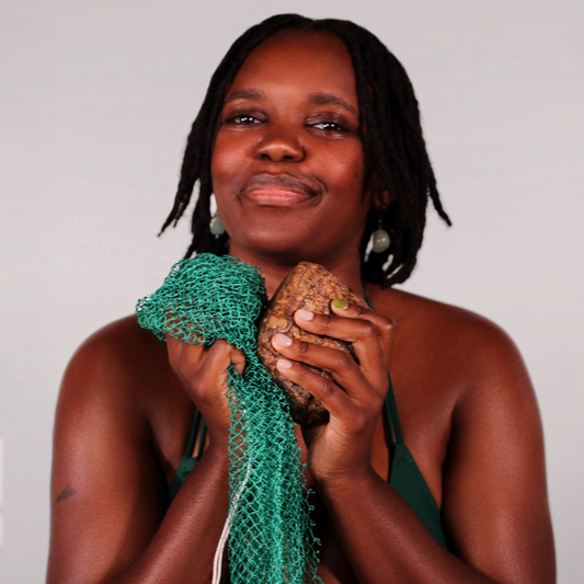Woman using African net sponge for body exfoliation and skin cleansing